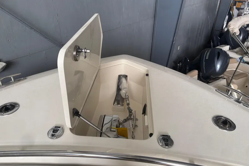 Slide: The Image of Open anchor compartment on a 2026 Scout 330 LXF boat, showcasing storage and equipment. - 22