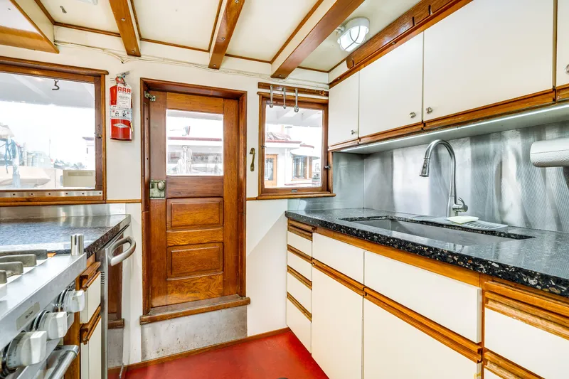 Slide: The Image of 1941 Custom Sagstad Fantail kitchen with wood accents and modern appliances. - 39