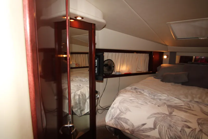 Slide: The Image of Interior cabin of 2008 Sea Ray 38 Sundancer with bed and mirror. - 40