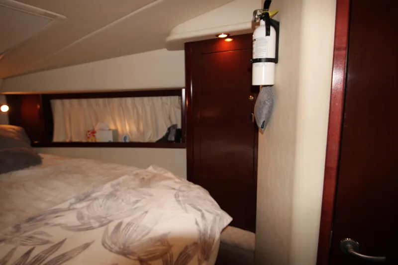 Slide: The Image of Interior cabin of 2008 Sea Ray 38 Sundancer with bed and fire extinguisher. - 42