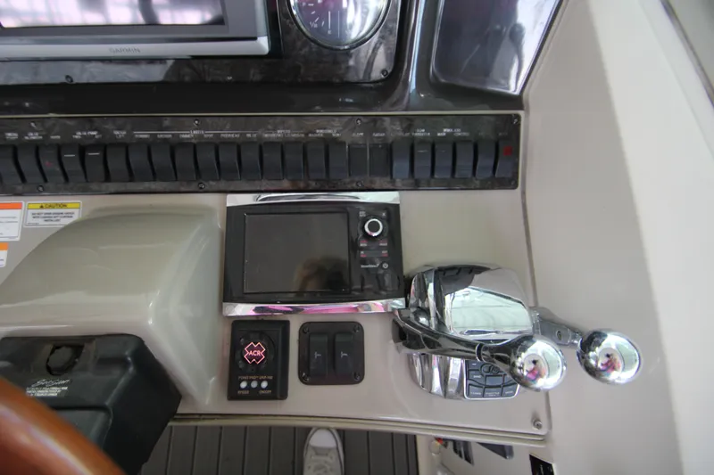 Slide: The Image of Control panel of 2008 Sea Ray 38 Sundancer boat with navigation equipment and throttle controls. - 23