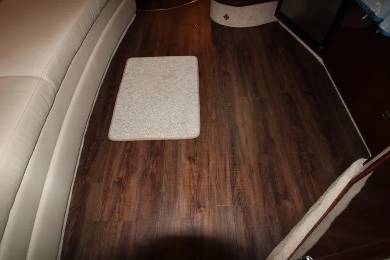 Slide: The Image of Interior of 2008 Sea Ray 38 Sundancer with wood flooring and beige seating. - 46