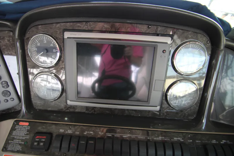 Slide: The Image of 2008 Sea Ray 38 Sundancer dashboard with gauges and central display. - 29