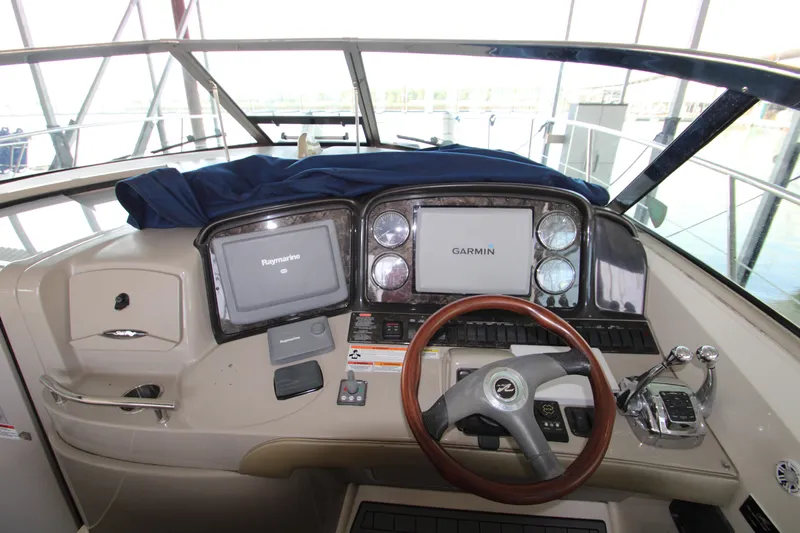 Slide: The Image of 2008 Sea Ray 38 Sundancer helm with Garmin navigation system and wood-accented steering wheel. - 21