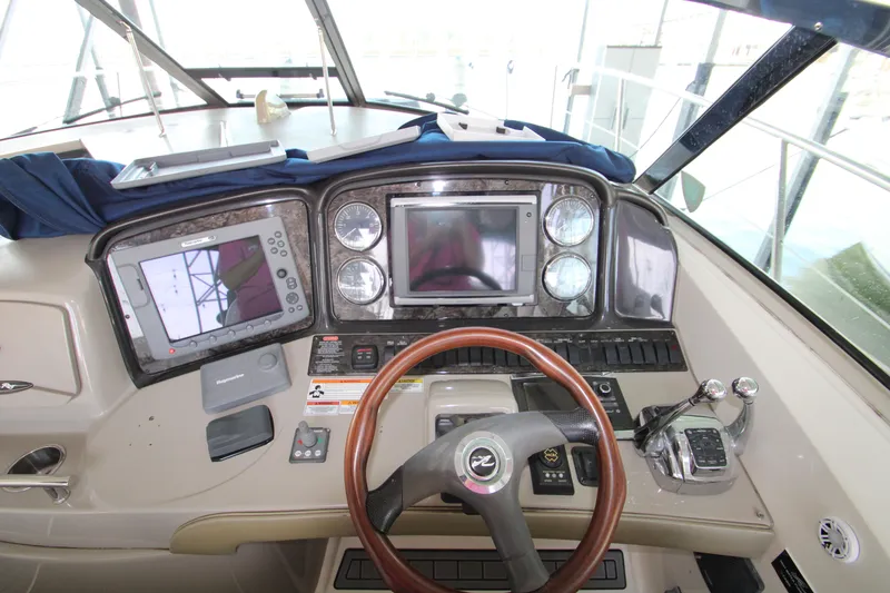 Slide: The Image of Cockpit of 2008 Sea Ray 38 Sundancer with navigation equipment and steering wheel. - 22