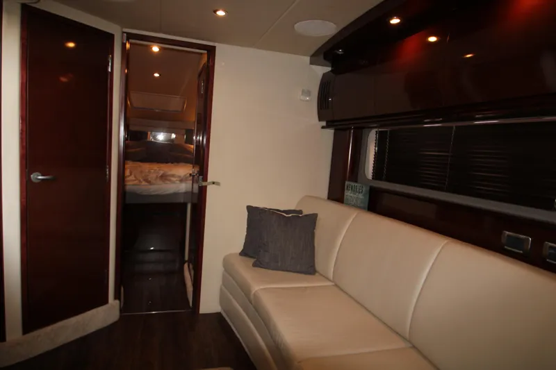 Slide: The Image of Interior of 2008 Sea Ray 38 Sundancer with beige sofa and cozy cabin. - 35