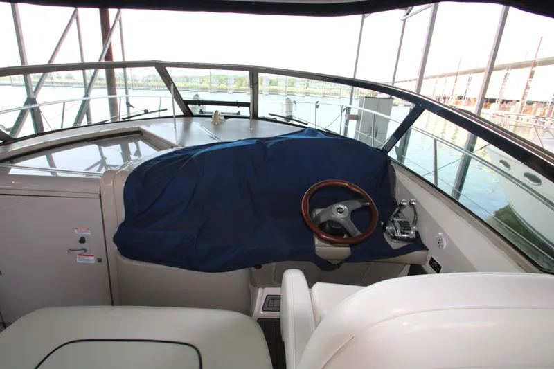 Slide: The Image of 2008 Sea Ray 38 Sundancer helm with covered dashboard and leather steering wheel. - 19