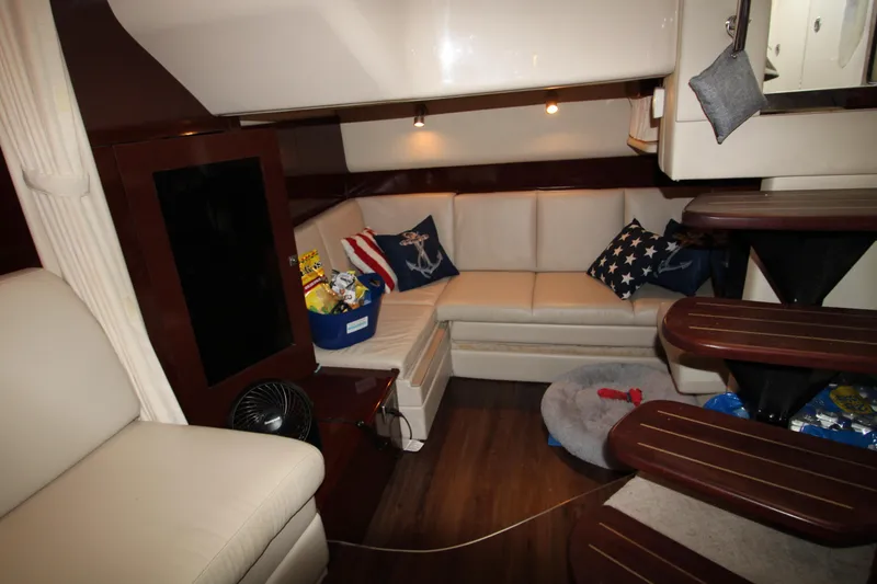 Slide: The Image of Interior of 2008 Sea Ray 38 Sundancer with cozy seating and nautical decor. - 47