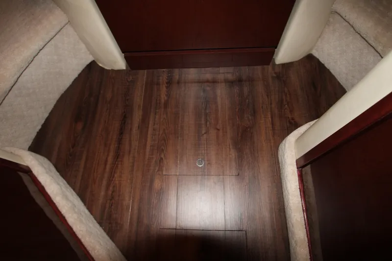 Slide: The Image of Interior view of 2008 Sea Ray 38 Sundancer with wood flooring and carpeted sides. - 45
