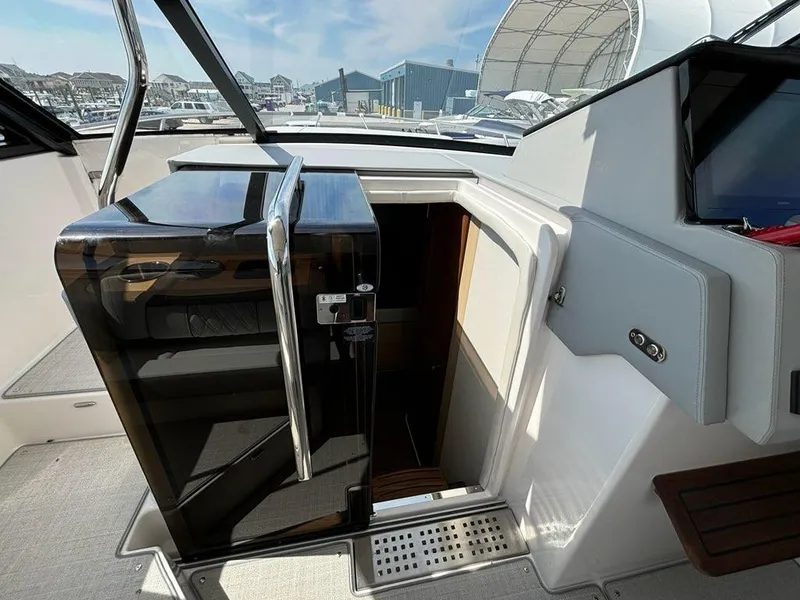 Slide: The Image of 2025 Regal 36 XO yacht interior with sleek cabin entrance and modern design elements. - 37
