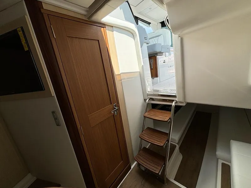Slide: The Image of Interior of 2025 Regal 36 XO yacht with wooden door and ladder. - 38