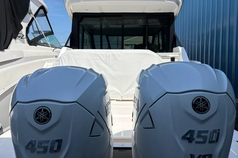 Slide: The Image of 2026 Regal 36 XO boat with twin Yamaha 450 V8 engines, docked in marina. - 47