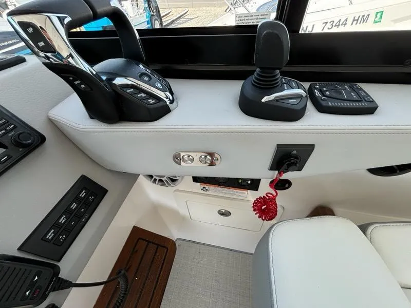 Slide: The Image of Control panel of 2025 Regal 36 XO boat with joystick and throttle controls. - 36