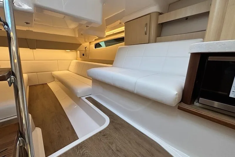 Slide: The Image of Luxurious interior of 2026 Regal 36 XO yacht with white seating and wood flooring. - 56
