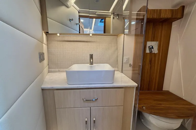 Slide: The Image of Modern bathroom interior of 2026 Regal 36 XO yacht with sleek sink and wooden accents. - 60
