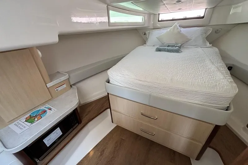 Slide: The Image of 2026 Regal 36 XO yacht cabin with cozy bed and modern amenities. - 51