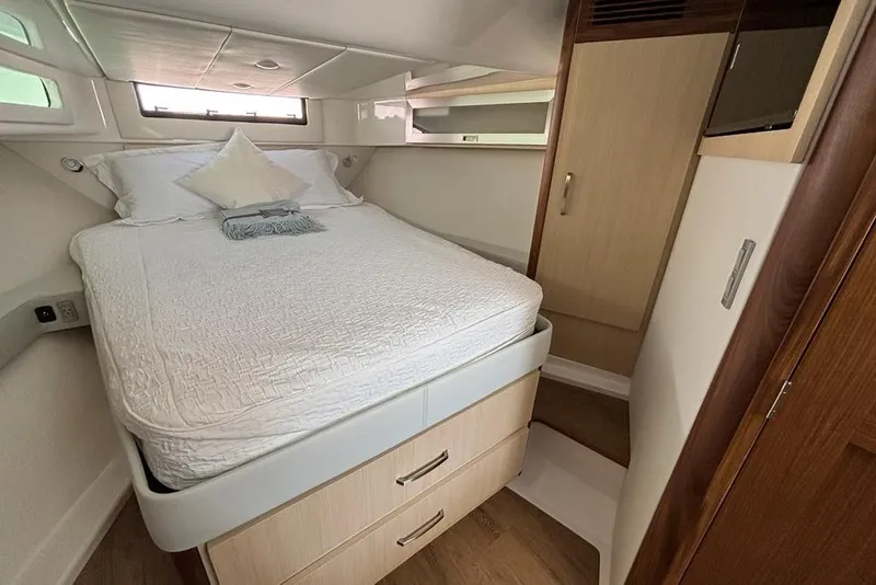 Slide: The Image of Luxurious cabin interior of 2026 Regal 36 XO yacht with cozy bed and storage. - 52