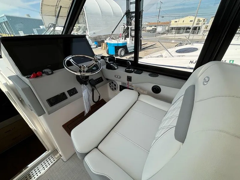Slide: The Image of 2025 Regal 36 XO boat cockpit with modern steering and controls. - 34