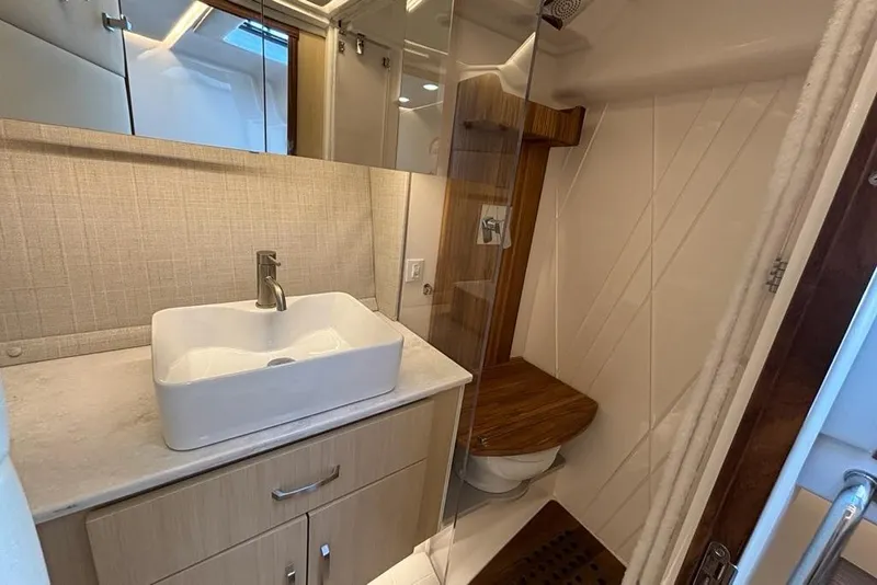 Slide: The Image of Luxurious bathroom in 2026 Regal 36 XO yacht with modern sink and wooden accents. - 58
