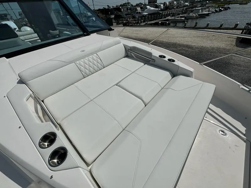 Slide: The Image of 2025 Regal 36 XO boat with luxurious white seating and cup holders. - 42
