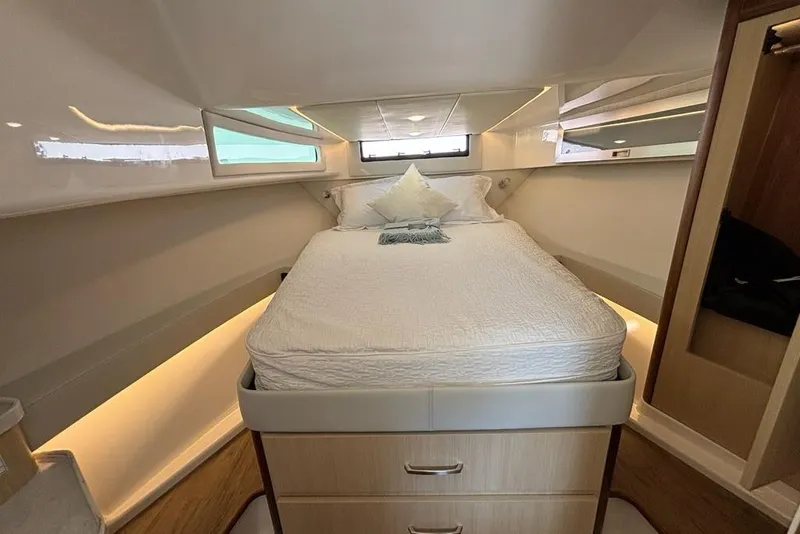 Slide: The Image of Luxurious cabin interior of 2026 Regal 36 XO yacht with cozy bed and ambient lighting. - 53