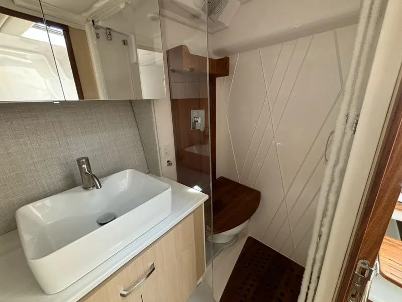 Slide: The Image of Modern bathroom in 2025 Regal 36 XO yacht with sleek sink and shower. - 39