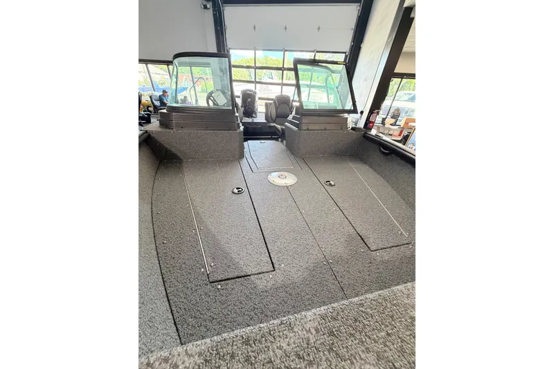 Slide: The Image of 2027 Lund 1700 Explorer Sport boat interior with dual windshields and spacious deck. - 17