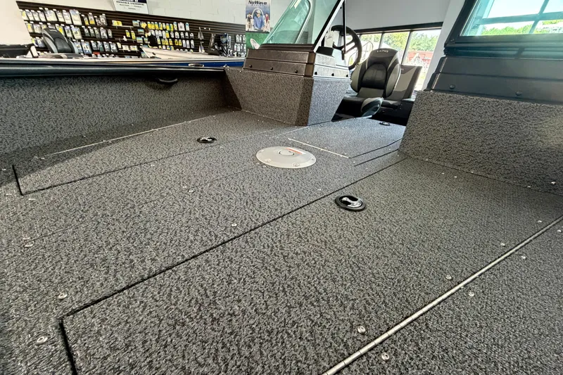 Slide: The Image of 2027 Lund 1700 Explorer Sport boat interior with textured flooring and seating. - 19