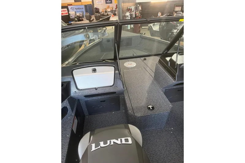 Slide: The Image of 2027 Lund 1700 Explorer Sport boat interior with seating and storage compartments. - 16