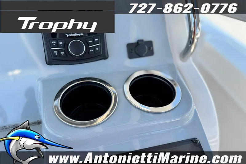 Slide: The Image of 2026 Bayliner Trophy T20CC boat console with cup holders and audio controls. - 20