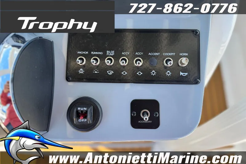 Slide: The Image of Control panel of 2026 Bayliner Trophy T20CC boat with switches and contact information. - 18