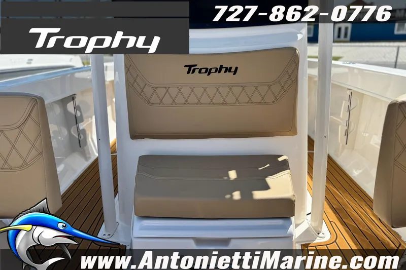 Slide: The Image of 2026 Bayliner Trophy T20CC boat interior with tan seating and wood-style flooring. - 28