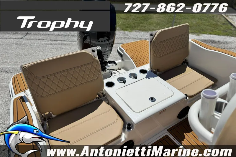 Slide: The Image of 2026 Bayliner Trophy T20CC boat interior with tan seating and fishing rod holders. - 12
