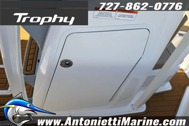 Slide: The Image of 2026 Bayliner Trophy T20CC boat hatch with contact details and logo. - 25