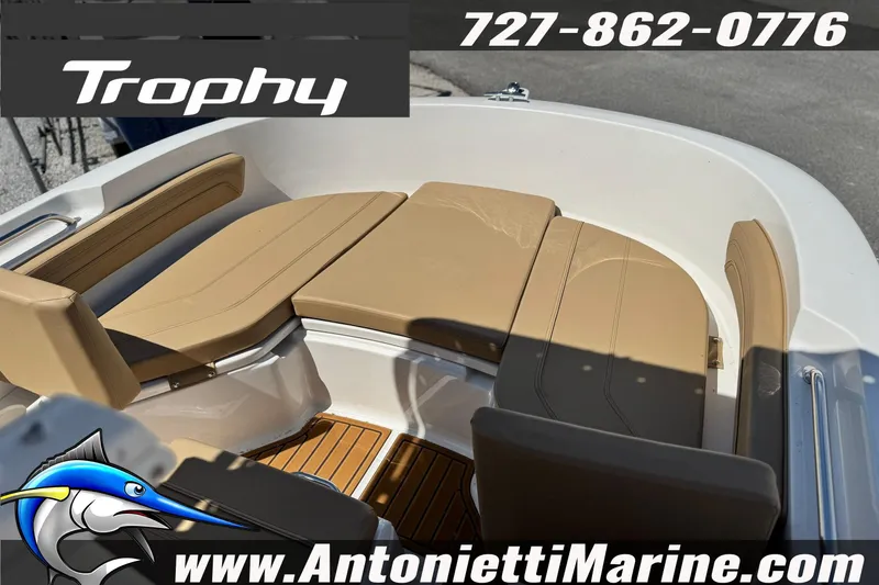 Slide: The Image of 2026 Bayliner Trophy T20CC boat interior with tan seating, logo, and contact details. - 27
