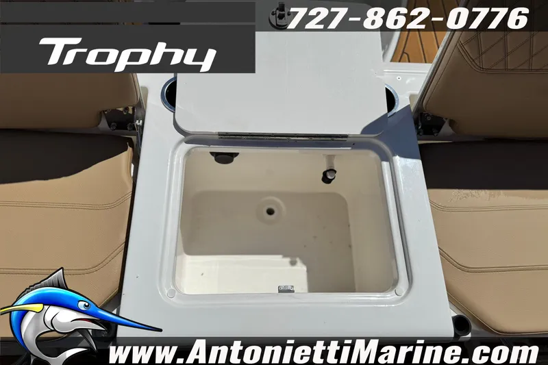 Slide: The Image of 2026 Bayliner Trophy T20CC boat interior with storage compartment, featuring beige seating. - 14