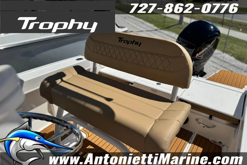 Slide: The Image of 2026 Bayliner Trophy T20CC boat interior with tan seating and Mercury engine. - 10