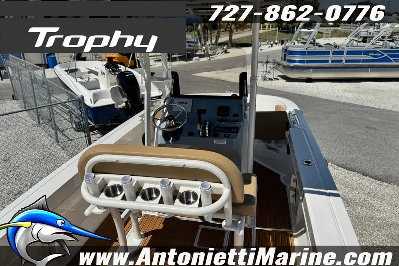 Slide: The Image of 2026 Bayliner Trophy T20CC boat interior with helm, rod holders, and seating at Antonietti Marine. - 8