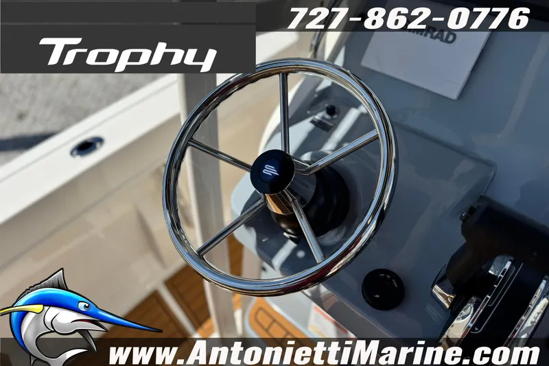 Slide: The Image of Steering wheel of 2026 Bayliner Trophy T20CC boat, featuring marine branding and contact details. - 21