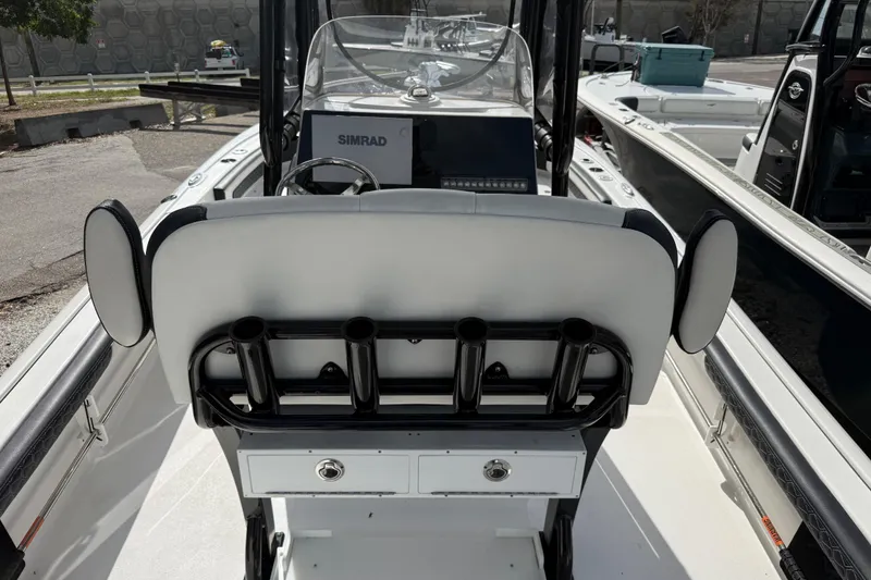 Slide: The Image of 2025 Tidewater 2300 Carolina Bay boat interior with rod holders and Simrad navigation system. - 6