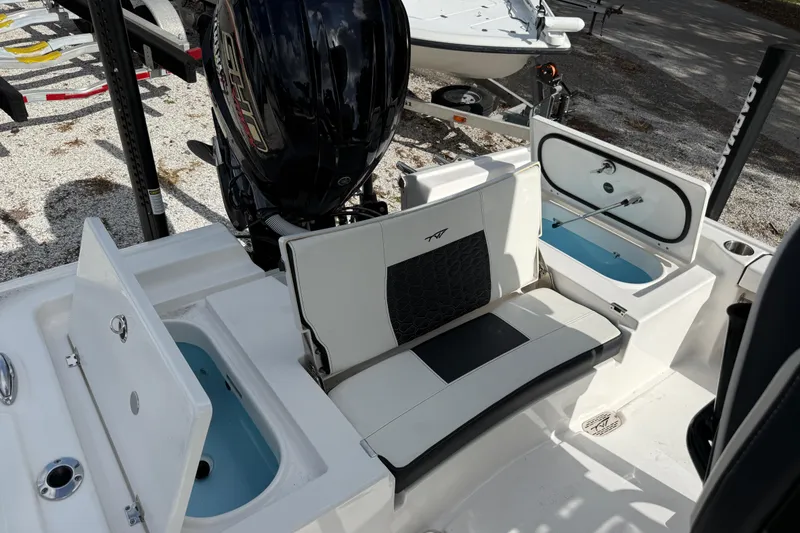 Slide: The Image of 2025 Tidewater 2300 Carolina Bay boat interior with seating and storage compartments. - 5