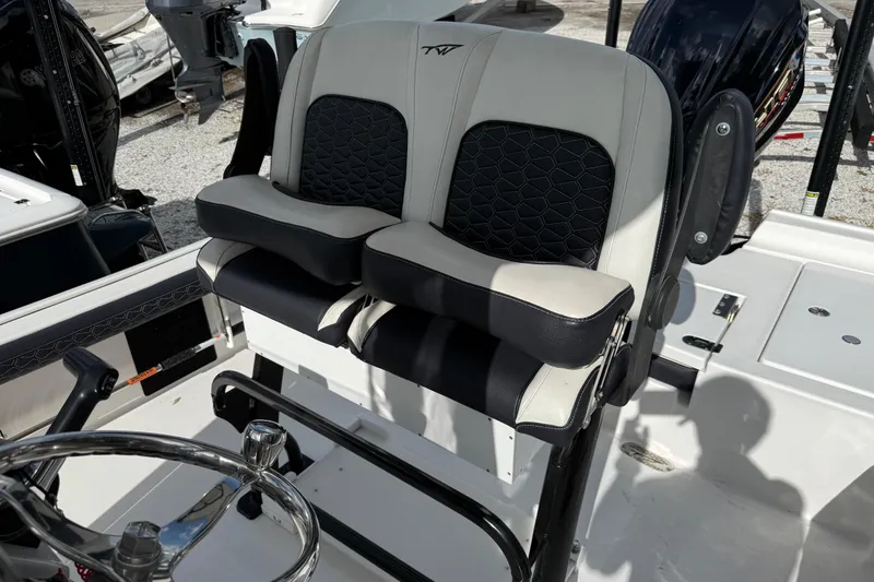 Slide: The Image of 2025 Tidewater 2300 Carolina Bay boat seats with black and white upholstery. - 10