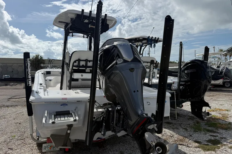 Slide: The Image of 2025 Tidewater 2300 Carolina Bay boat with powerful outboard motor, parked outdoors. - 3