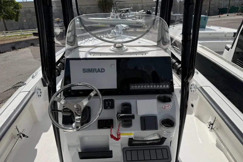 Slide: The Image of 2025 Tidewater 2300 Carolina Bay boat console with Simrad display and steering wheel. - 7