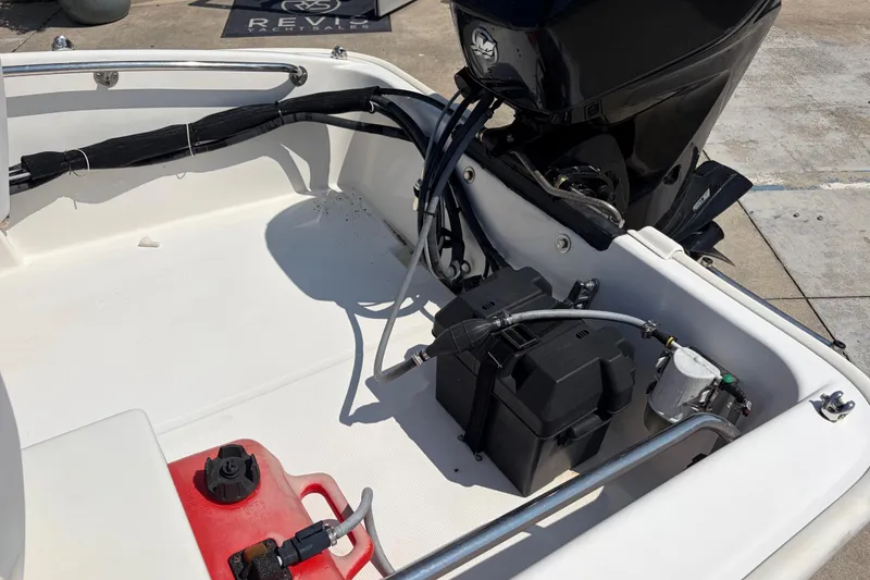 Slide: The Image of 2011 Boston Whaler 130 Super Sport boat interior with engine and fuel tank. - 10