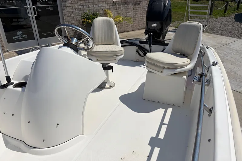 Slide: The Image of 2011 Boston Whaler 130 Super Sport boat interior with steering wheel and seating. - 8