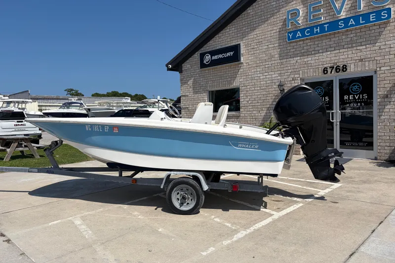 Slide: The Image of 2011 Boston Whaler 130 Super Sport boat on trailer at Revis Yacht Sales. - 2