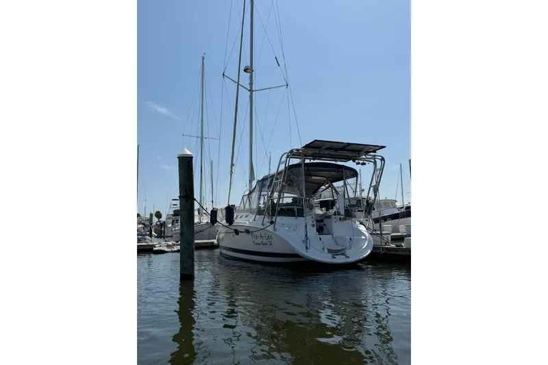 Slide: The Image of Sailboat docked at marina, 2004 Hunter 466 model, under clear blue sky. - 3