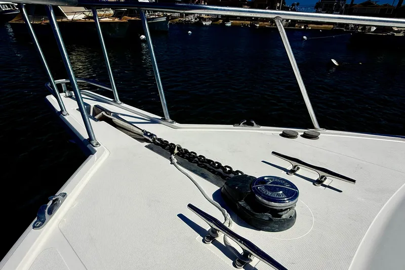 Slide: The Image of Bow of 2004 Cabo 35 Flybridge boat with anchor chain and winch. - 67