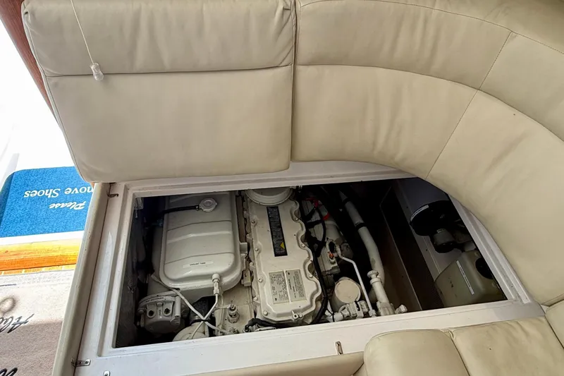 Slide: The Image of Engine compartment of a 2004 Cabo 35 Flybridge yacht, under beige seating. - 65